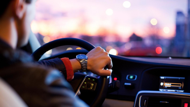 skats no muguras ar vīrieti pie vieglā auto stūres