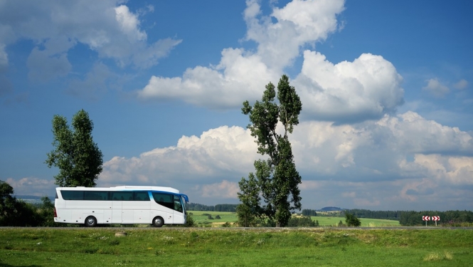 autobuss lauku ainavā saulainā dienā