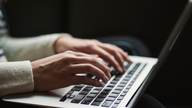 rokas uz portatīvā datora