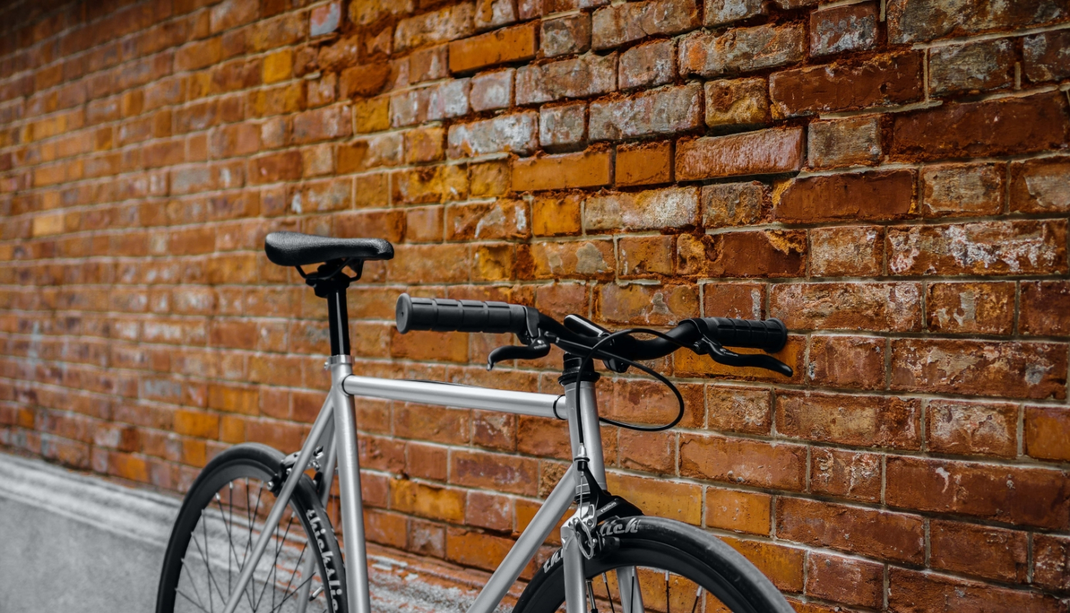pret ķieģeļu sienu atstutēts velosipēds